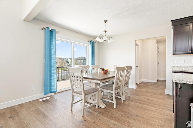 dining area featuring baseboards, visible vents, an inviting chandelier, and light wood-style floors