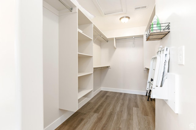 spacious closet featuring wood finished floors and visible vents
