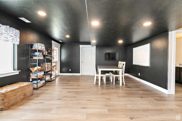 dining room with baseboards, light wood-style flooring, and recessed lighting