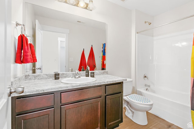 full bathroom featuring toilet, visible vents, shower / washtub combination, wood finished floors, and vanity