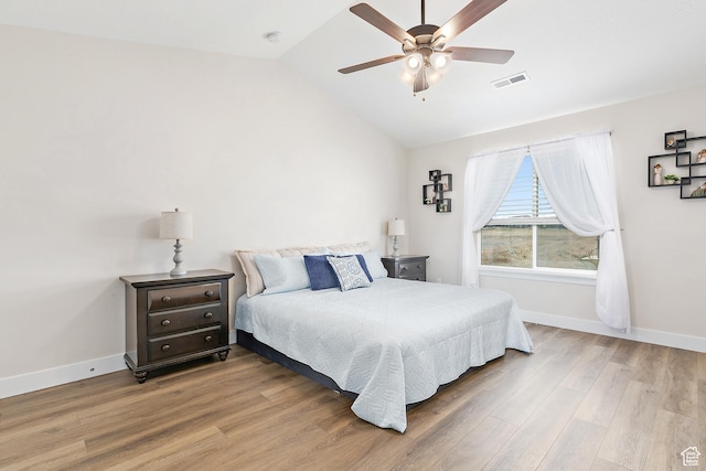 bedroom with vaulted ceiling, baseboards, visible vents, a ceiling fan, and wood finished floors