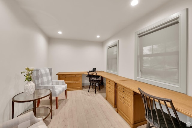 office area featuring light wood-style flooring, built in desk, and recessed lighting