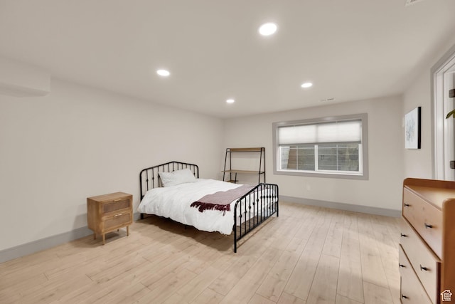bedroom with recessed lighting, light wood-style floors, and baseboards