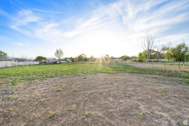 view of yard featuring fence and a rural view
