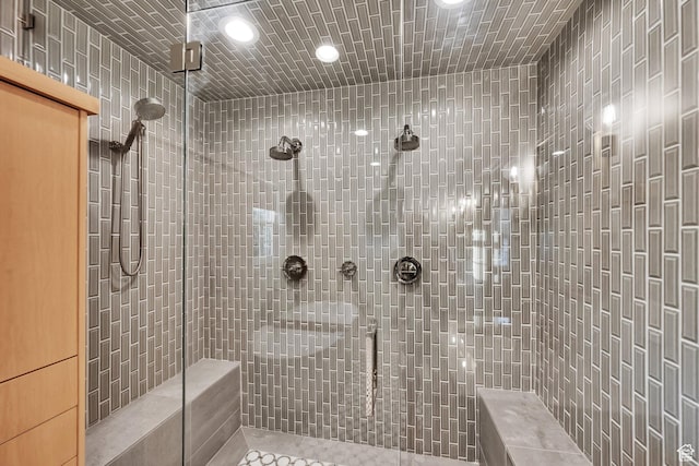 bathroom with a tile shower, tile patterned floors, and recessed lighting