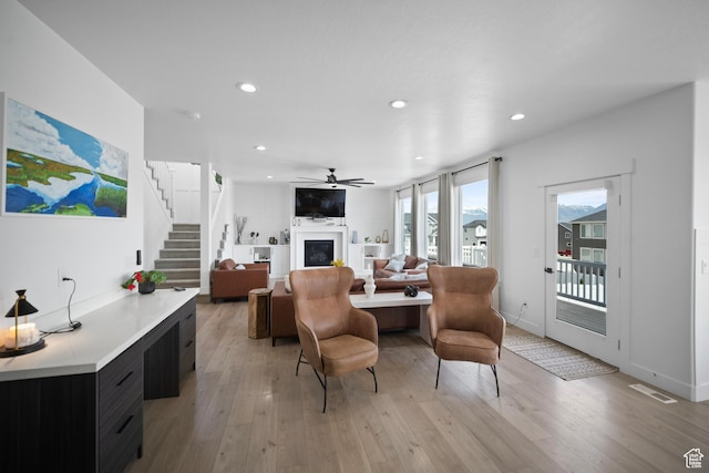 2848 S Preening Way, Saratoga Springs, UT 84045 - living room with a fireplace, light wood finished floors, recessed lighting, stairway, and a ceiling fan