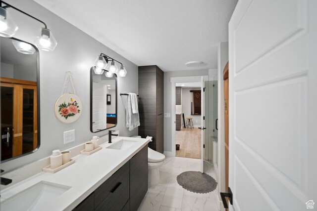 2848 S Preening Way, Saratoga Springs, UT 84045 - bathroom featuring toilet, double vanity, a shower with door, and marble finish floors