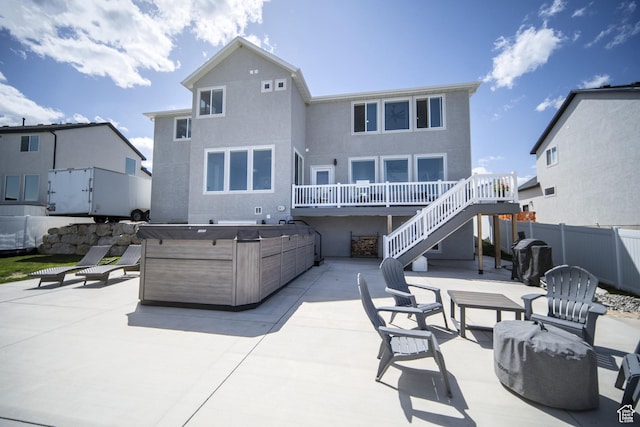 2848 S Preening Way, Saratoga Springs, UT 84045 - back of property featuring a patio, a hot tub, stairs, stucco siding, and a deck