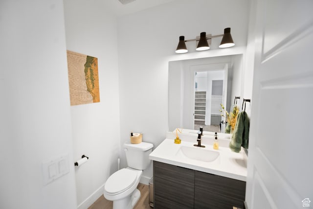 2848 S Preening Way, Saratoga Springs, UT 84045 - half bath featuring toilet, vanity, wood finished floors, and baseboards