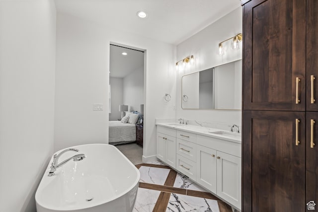 949 W Torrey Pines Dr, Richfield, UT 84701 - ensuite bathroom with a sink, double vanity, a freestanding bath, baseboards, and recessed lighting