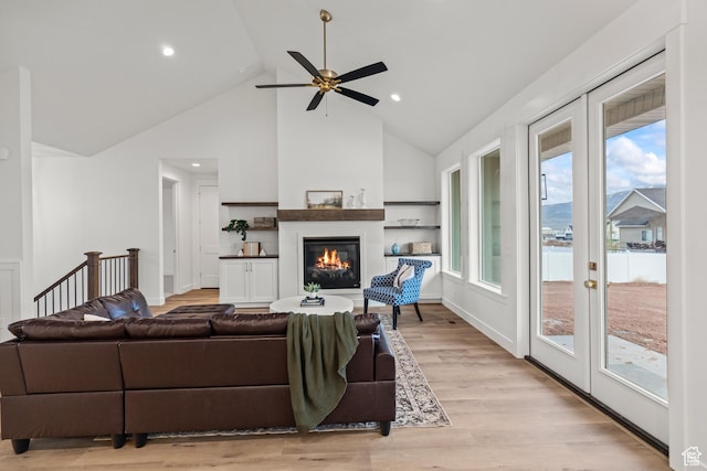949 W Torrey Pines Dr, Richfield, UT 84701 - living area with high vaulted ceiling, a ceiling fan, a glass covered fireplace, light wood-type flooring, and recessed lighting