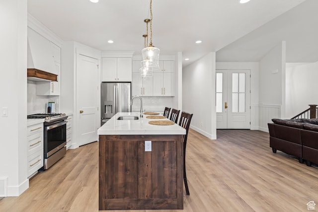949 W Torrey Pines Dr, Richfield, UT 84701 - kitchen featuring a sink, light wood-style floors, light countertops, decorative light fixtures, and appliances with stainless steel finishes