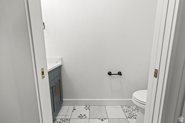 949 W Torrey Pines Dr, Richfield, UT 84701 - half bathroom featuring tile patterned flooring, baseboards, toilet, and vanity