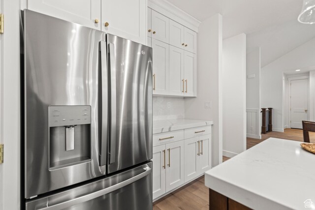 949 W Torrey Pines Dr, Richfield, UT 84701 - kitchen with stainless steel refrigerator with ice dispenser, white cabinetry, light stone countertops, and light wood-type flooring