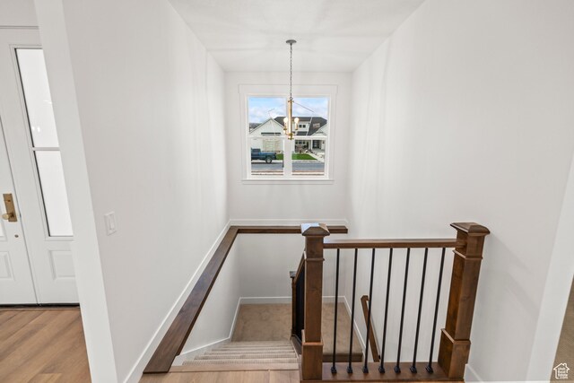 949 W Torrey Pines Dr, Richfield, UT 84701 - stairs with a chandelier, wood finished floors, and baseboards