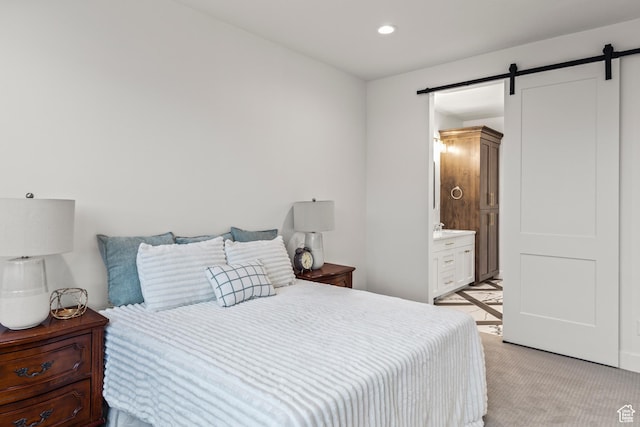 949 W Torrey Pines Dr, Richfield, UT 84701 - bedroom featuring a barn door, a sink, connected bathroom, light colored carpet, and recessed lighting