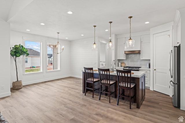 949 W Torrey Pines Dr, Richfield, UT 84701 - dining space featuring recessed lighting, wood finished floors, baseboards, and an inviting chandelier