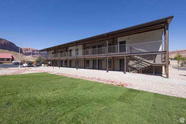 443 W Kane Creek Blvd Unit A206, Moab, UT 84532 - rear view of property featuring a lawn, stairs, and a mountain view