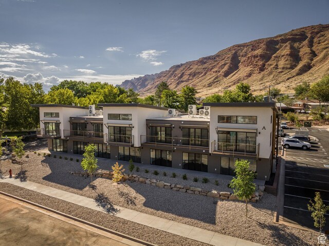 443 W Kane Creek Blvd Unit A206, Moab, UT 84532 - back of property featuring a balcony, a mountain view, and stucco siding