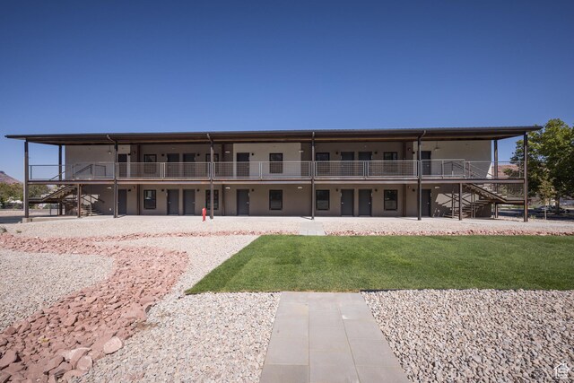 443 W Kane Creek Blvd Unit A206, Moab, UT 84532 - back of house featuring a lawn and stairway