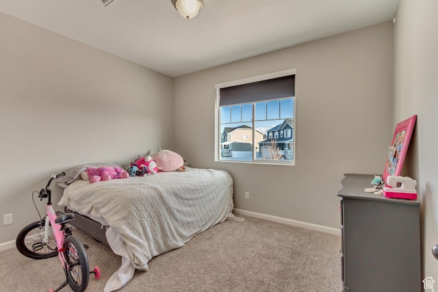 carpeted bedroom with baseboards