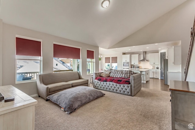 living room with light carpet, baseboards, high vaulted ceiling, and recessed lighting