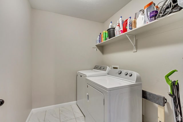 laundry area with independent washer and dryer, marble finish floor, baseboards, and laundry area