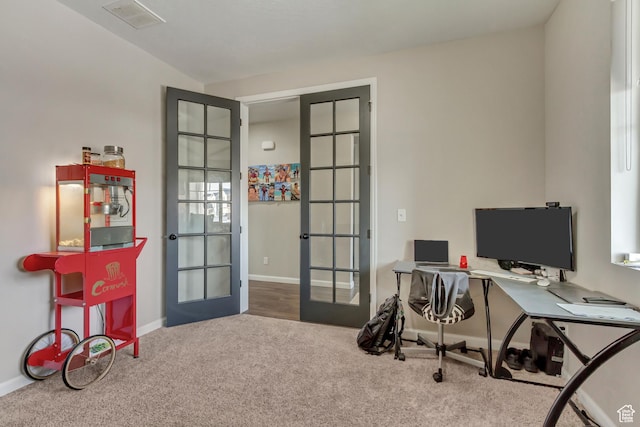 carpeted office space featuring visible vents, french doors, and baseboards