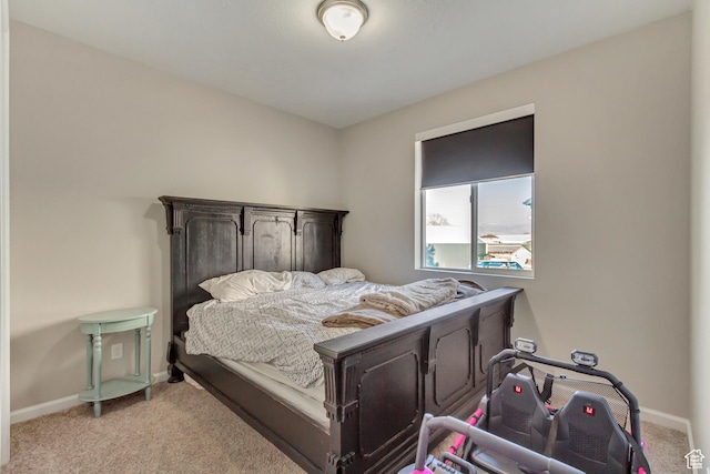 bedroom featuring baseboards and carpet flooring
