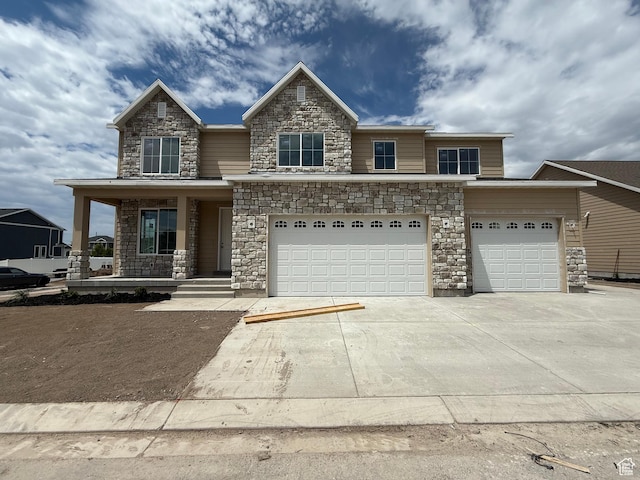89 N 2430 W Unit 4, Lehi, UT 84043 - view of front of property featuring concrete driveway, a porch, stone siding, and an attached garage
