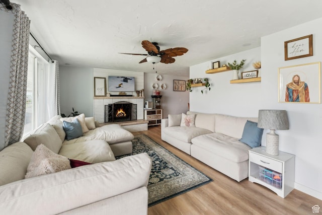 374 S Fairlane, Tooele, UT 84074 - living area featuring wood finished floors, a brick fireplace, baseboards, and ceiling fan