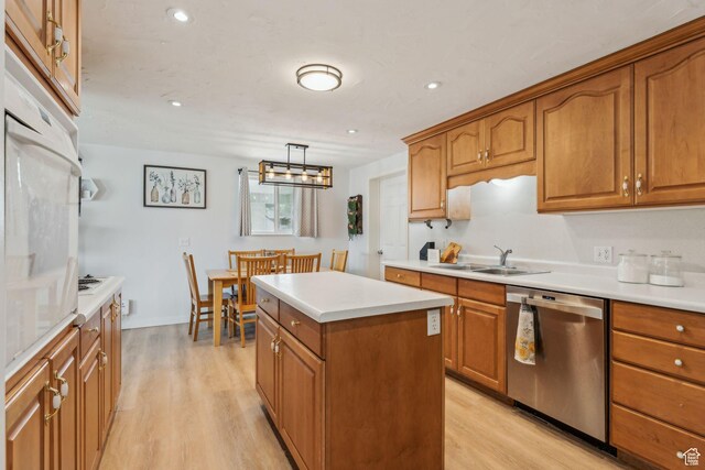 374 S Fairlane, Tooele, UT 84074 - kitchen with dishwasher, brown cabinets, a sink, and light wood-type flooring