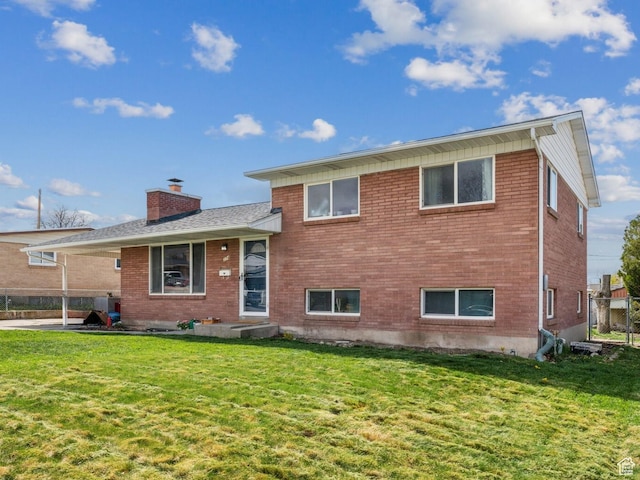 374 S Fairlane, Tooele, UT 84074 - split level home with a chimney, a front lawn, and brick siding