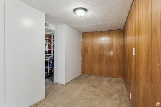 374 S Fairlane, Tooele, UT 84074 - hallway with wooden walls and concrete flooring