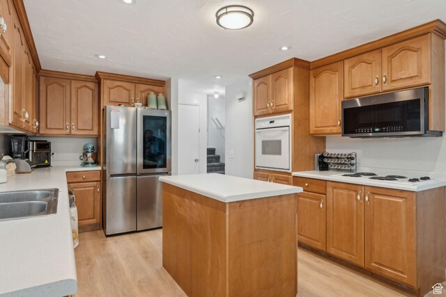 374 S Fairlane, Tooele, UT 84074 - kitchen featuring stainless steel appliances, a center island, light countertops, and light wood-style floors
