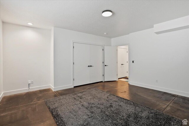 655 Wilard Peak Rd, Mantua, UT 84324 - unfurnished bedroom with baseboards and a textured ceiling