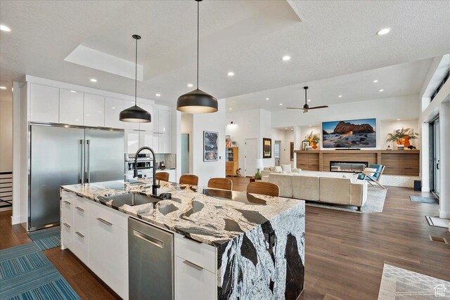 655 Wilard Peak Rd, Mantua, UT 84324 - kitchen with white cabinets, a sink, modern cabinets, an island with sink, and appliances with stainless steel finishes