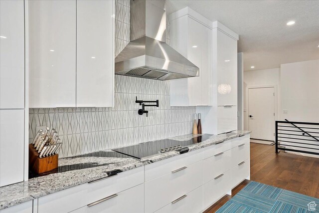 655 Wilard Peak Rd, Mantua, UT 84324 - kitchen featuring white cabinets, black electric cooktop, wall chimney range hood, modern cabinets, and dark wood-type flooring