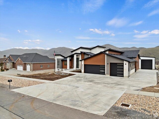655 Wilard Peak Rd, Mantua, UT 84324 - view of front of house featuring concrete driveway, a mountain view, and a garage