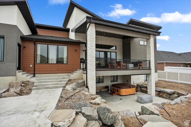 655 Wilard Peak Rd, Mantua, UT 84324 - rear view of house with a hot tub, a patio, a balcony, and fence