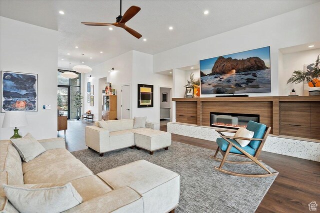 655 Wilard Peak Rd, Mantua, UT 84324 - living area with ceiling fan, a glass covered fireplace, wood finished floors, and recessed lighting