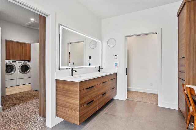 655 Wilard Peak Rd, Mantua, UT 84324 - bathroom with washing machine and dryer, tile patterned flooring, a sink, and double vanity