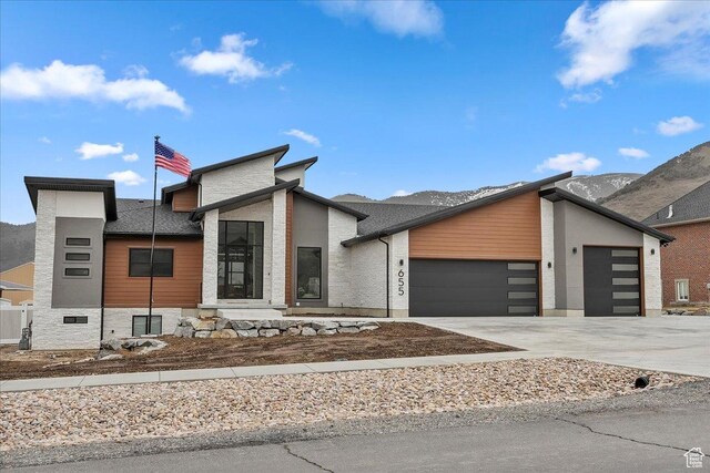 655 Wilard Peak Rd, Mantua, UT 84324 - contemporary house with driveway, a mountain view, and a garage
