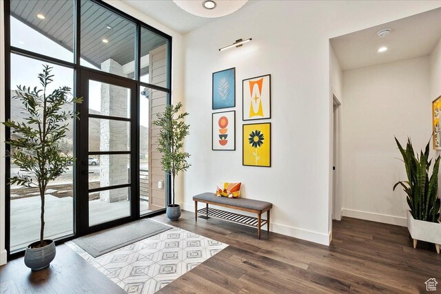 655 Wilard Peak Rd, Mantua, UT 84324 - interior space featuring expansive windows, baseboards, a towering ceiling, and wood finished floors