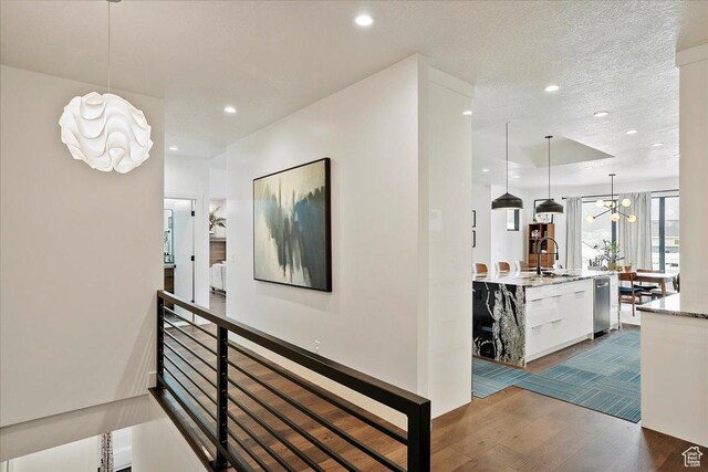 655 Wilard Peak Rd, Mantua, UT 84324 - hallway with recessed lighting, dark wood-type flooring, a sink, and an inviting chandelier
