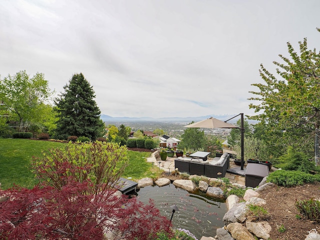 1022 E Northbonneville Dr N, Salt Lake City, UT 84103 - view of grassy yard with an outdoor living space, a garden pond, and a patio area