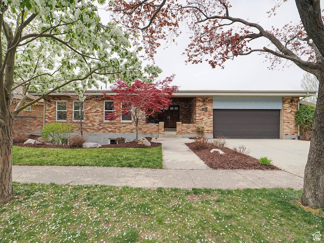 1022 E Northbonneville Dr N, Salt Lake City, UT 84103 - ranch-style home featuring brick siding, an attached garage, concrete driveway, and a front yard