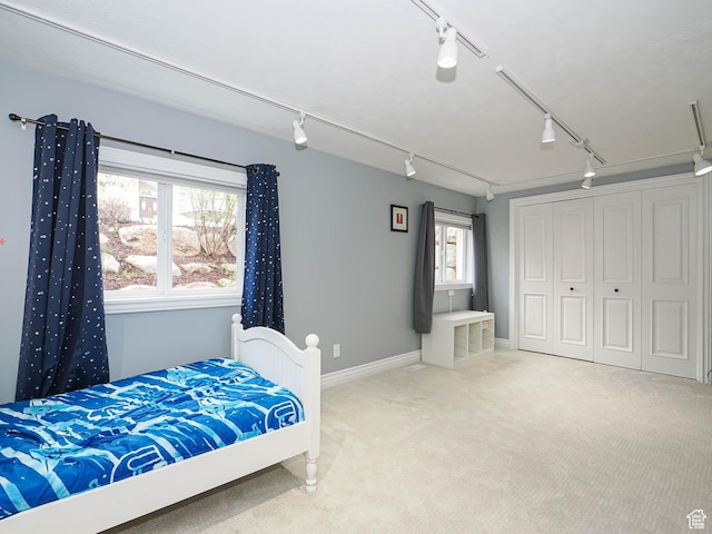 1022 E Northbonneville Dr N, Salt Lake City, UT 84103 - carpeted bedroom featuring track lighting, baseboards, and a closet