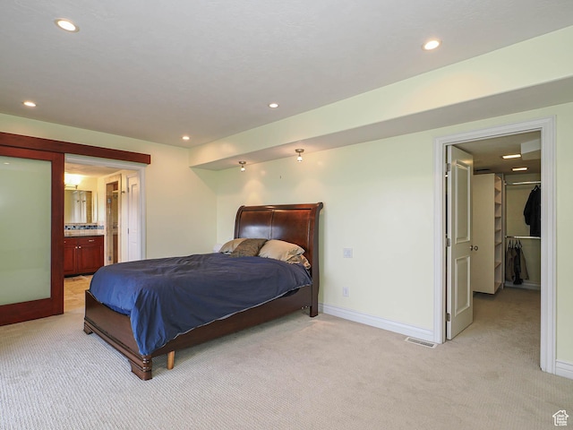 1022 E Northbonneville Dr N, Salt Lake City, UT 84103 - bedroom with light colored carpet, recessed lighting, baseboards, a spacious closet, and ensuite bathroom