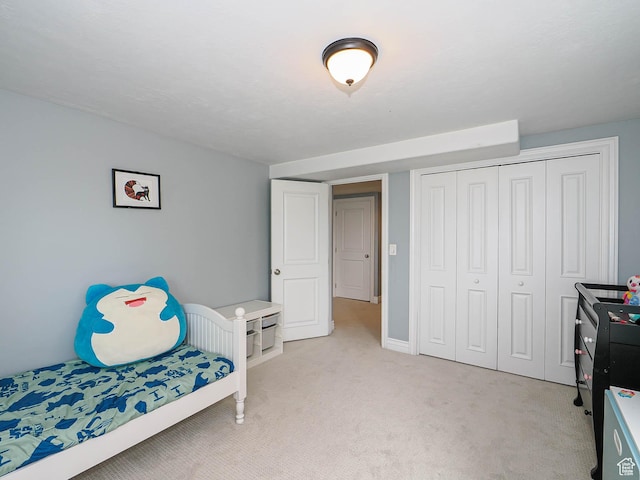 1022 E Northbonneville Dr N, Salt Lake City, UT 84103 - bedroom with light carpet, a closet, and baseboards